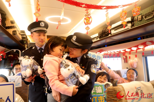 首都乘警在列车上开展“小年安全大讲堂”，伴旅客平安出行。人民网 李世奇摄